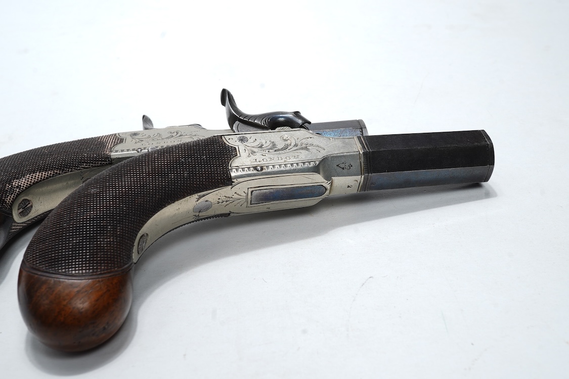 A pair of boxlock percussion pocket pistols with 4cm octagonal barrels, the frames engraved Lacy & Co., London, with London proof marks and rounded chequered walnut butts (2)